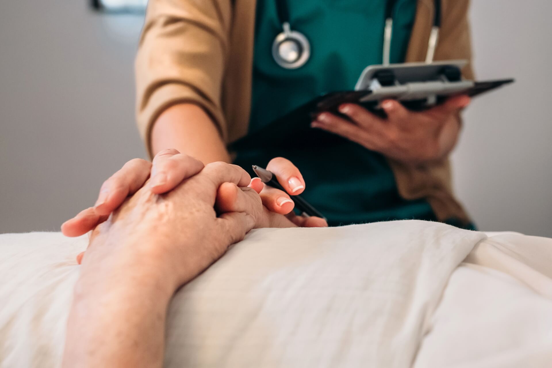 Female doctor comforting older patient