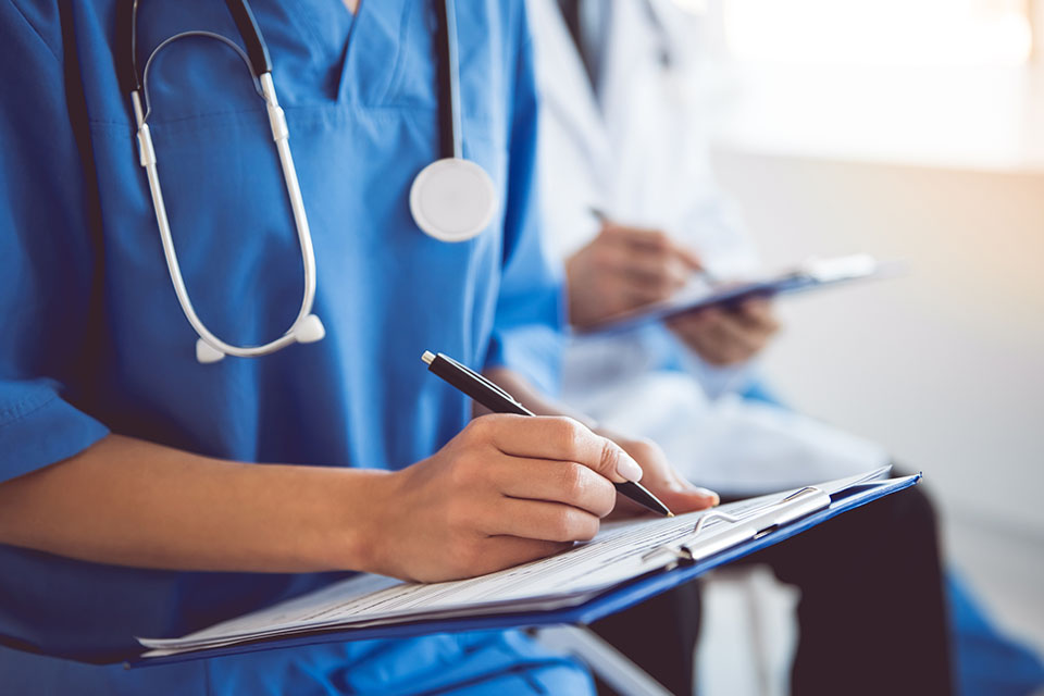 Close up of nurse holding clipboard