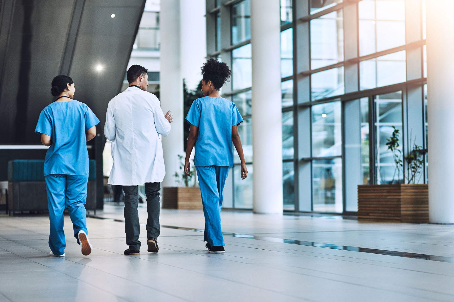 Medical staff walking through hospital entrance